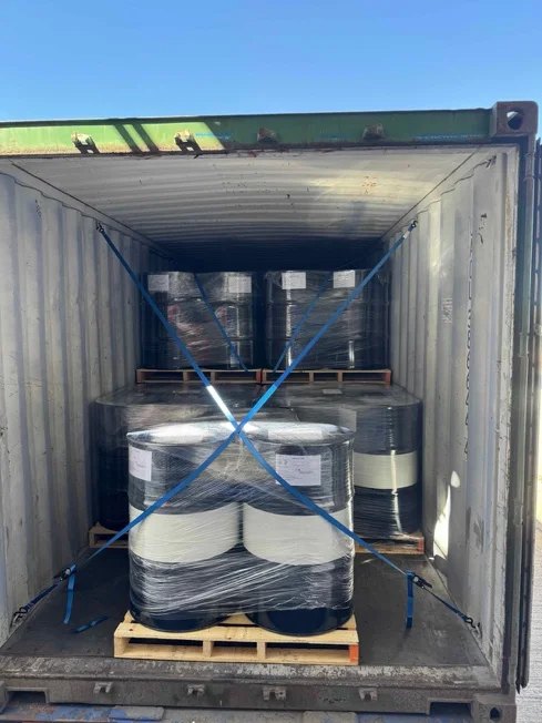 Palletized drums secured inside a shipping container, ready for export