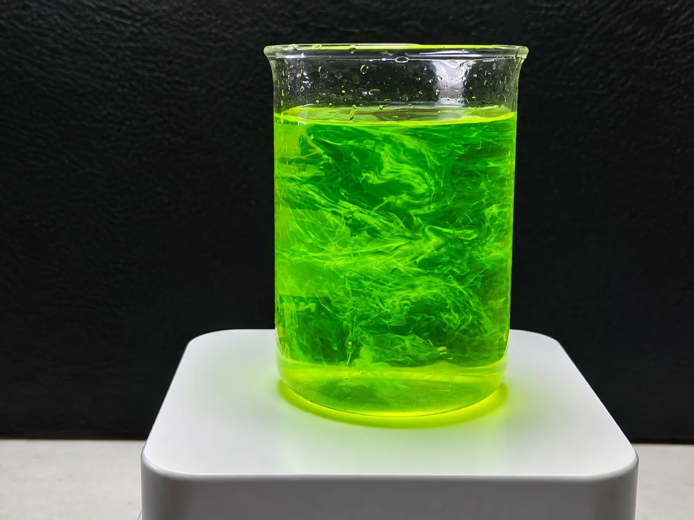 Fluorescent dye dispersing through solution under UV light
